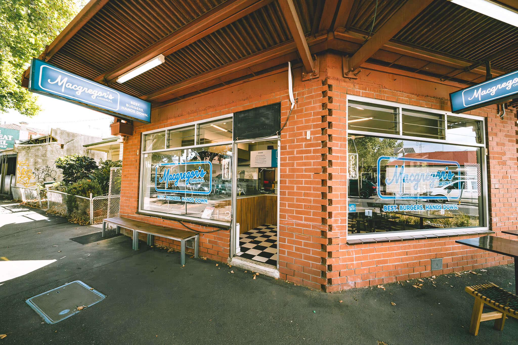 The Macgregor's Original shopfront on Nicholson St — red brick, teal signage, checkered tiles just inside the open door.